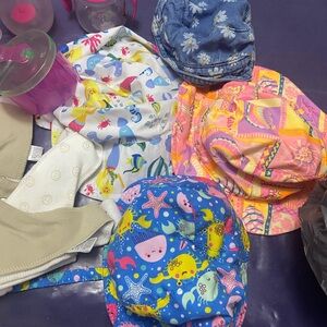 Infant lot includes hats, drool bibs, sippy cups, diapers size 3 and more